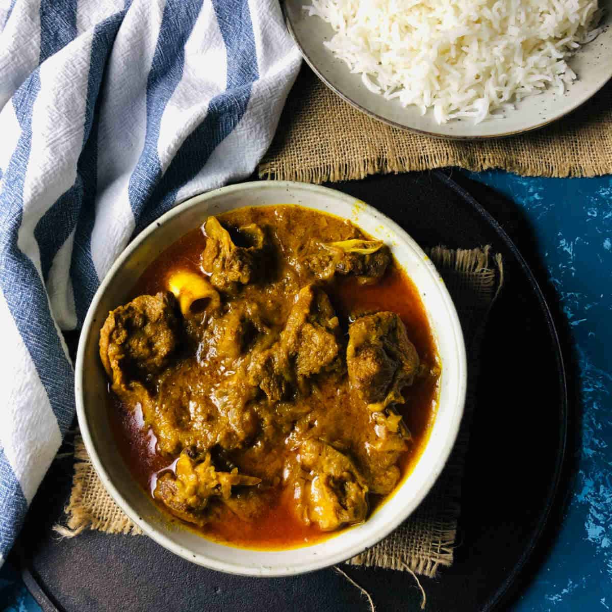 instant pot goat curry served with steamed rice.
