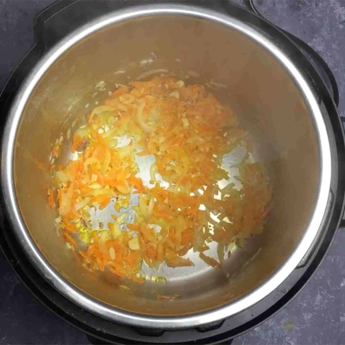 Saute onions and carrots in the Instant Pot.