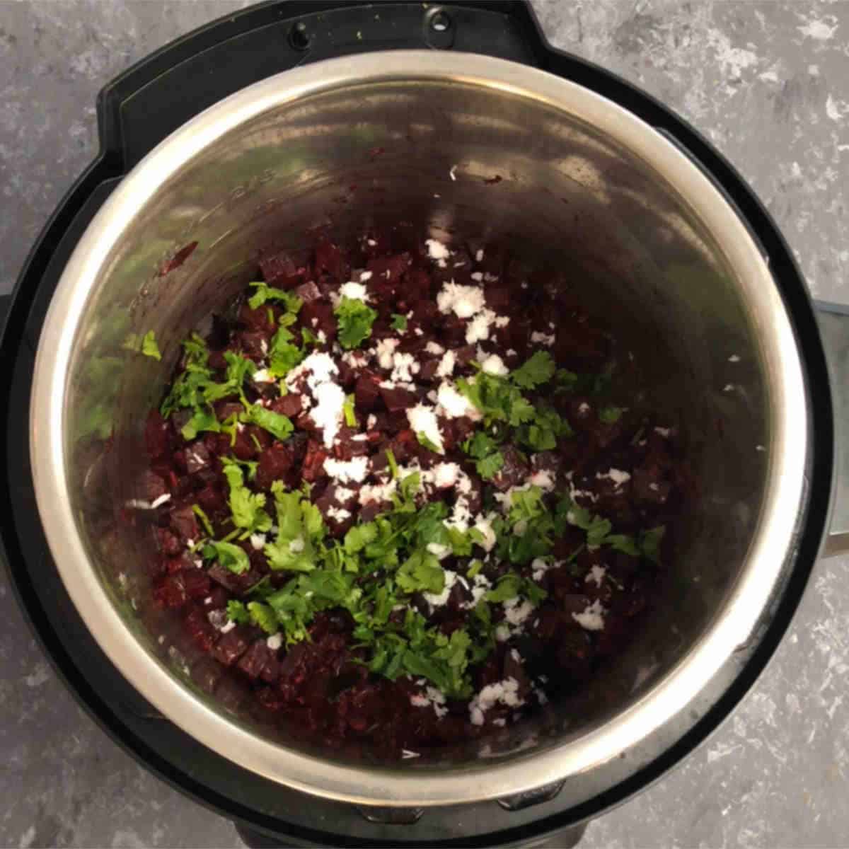 Instant pot beetroot palya garnished with coconut and cilantro.