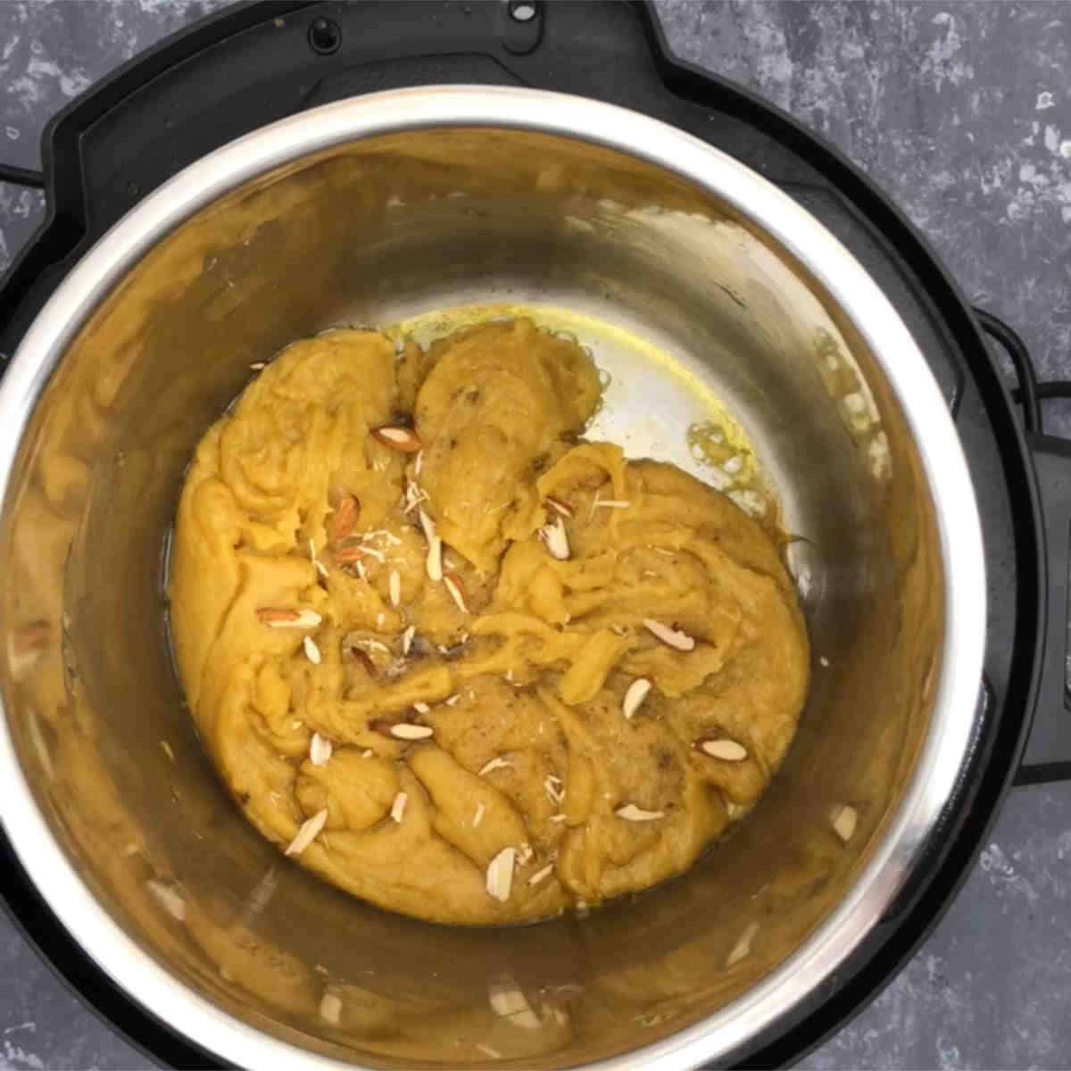 Add chopped nuts to moong dal halwa in Instant Pot.