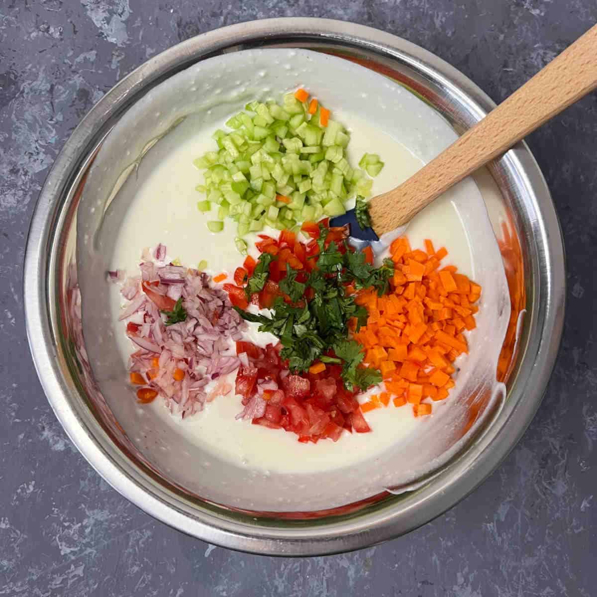 Add veggies and seasoning to yogurt.