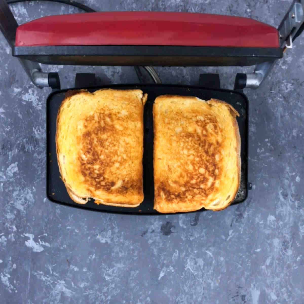 Grill the sandwich in a panini press till golden.