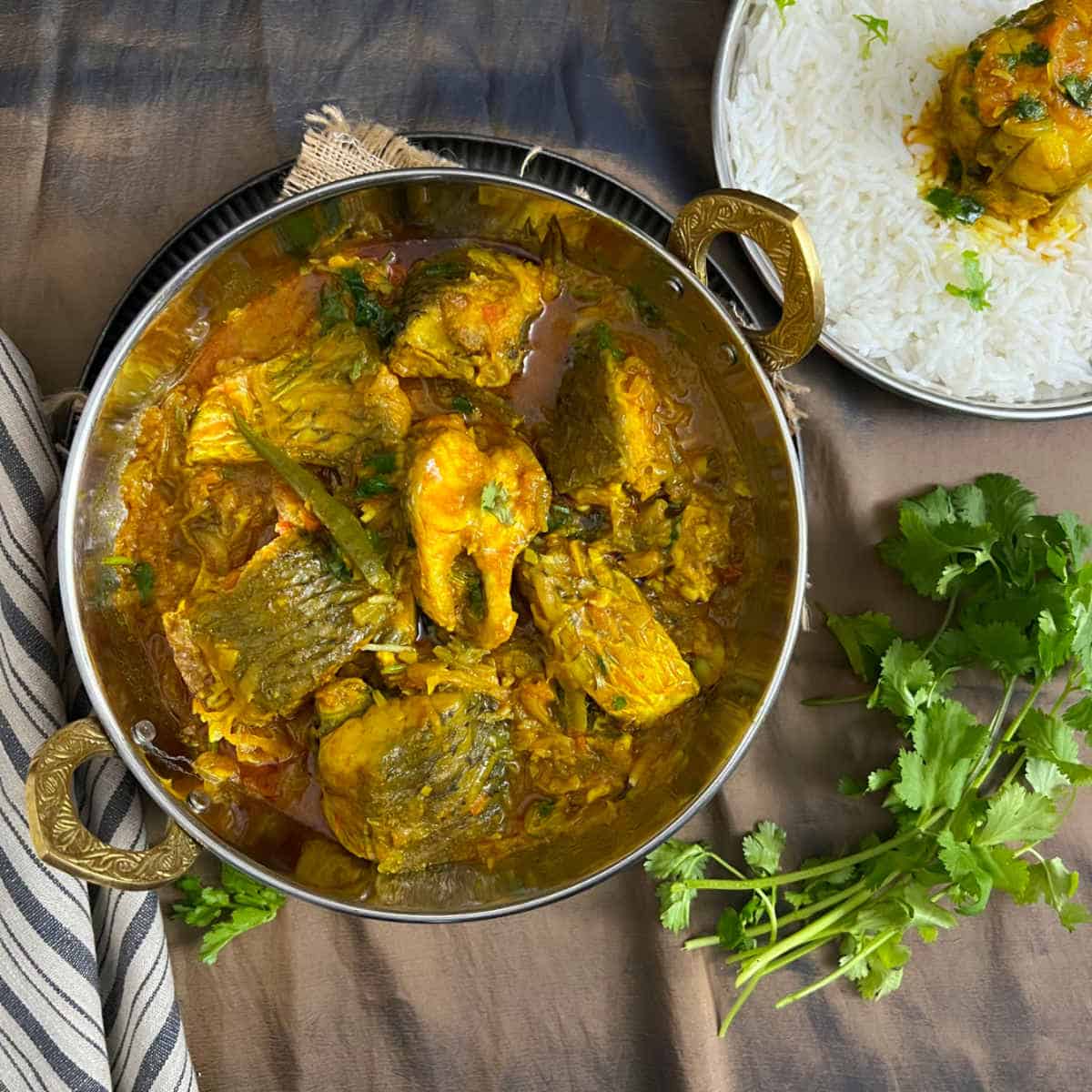 Bengali fish curry served in a traditional bowl.