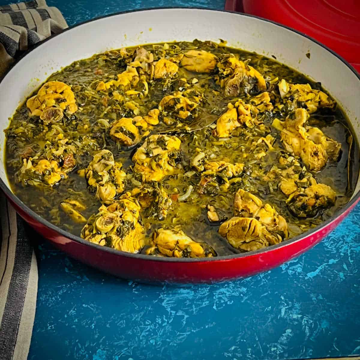Methi chicken placed in a Dutch pan.