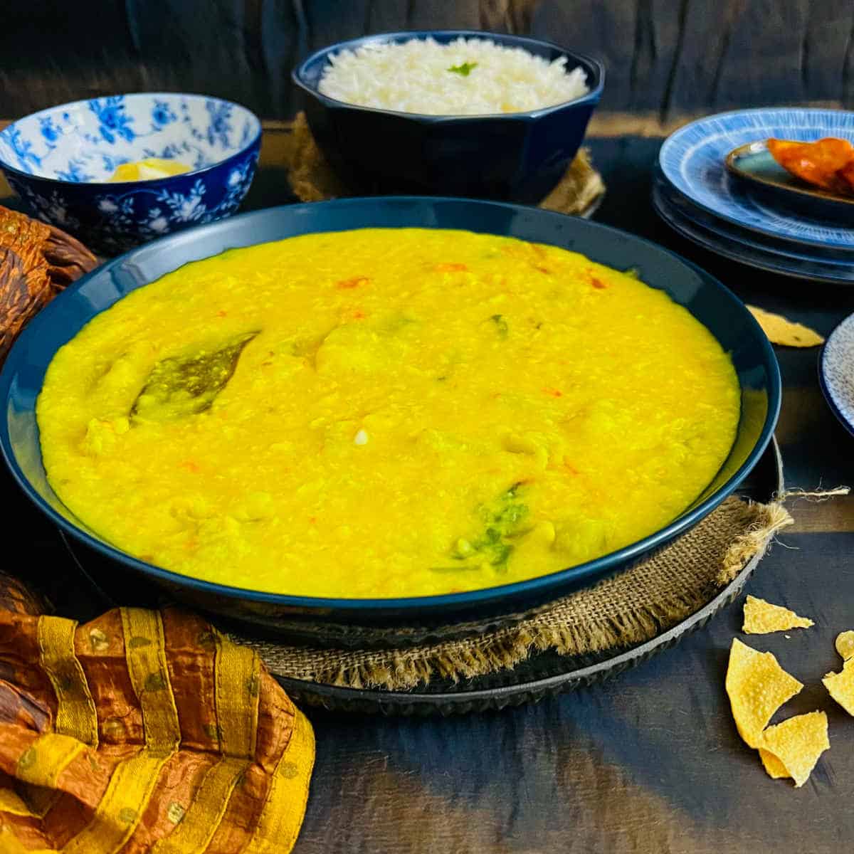 Bengali lau dal served with rice and papadums.