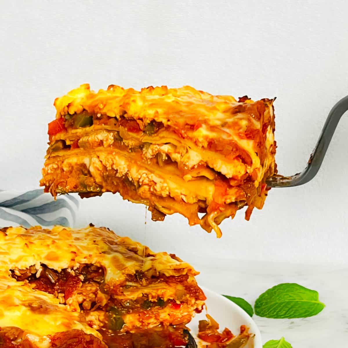 Paneer lasagna slice on a spatual.