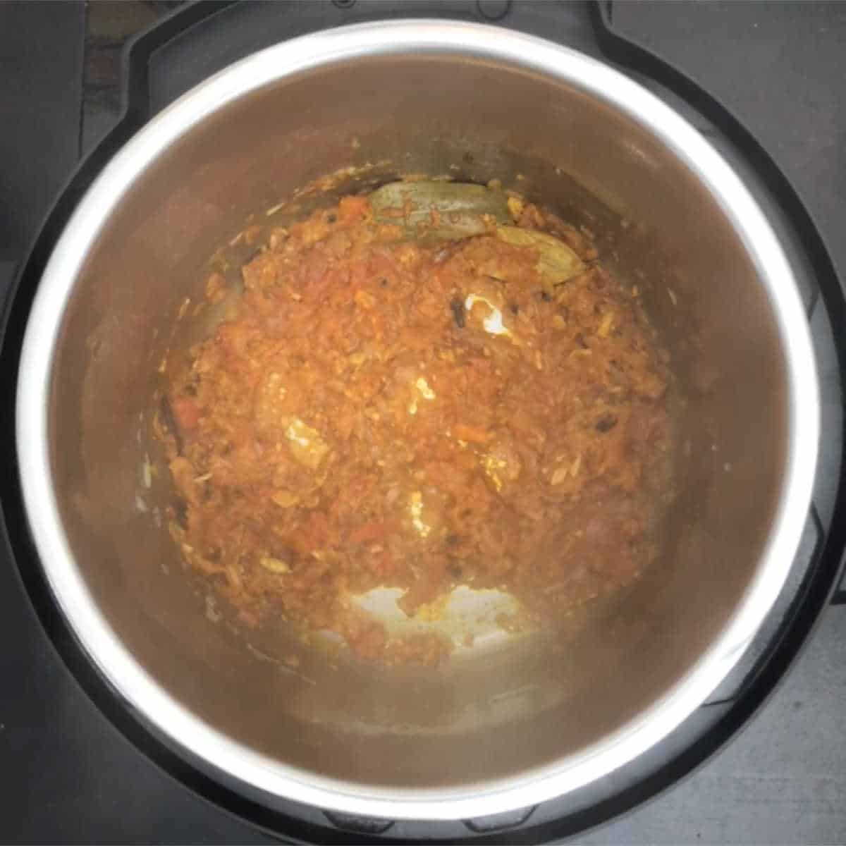 Step showing the cooked onion-tomato and spice masala base.