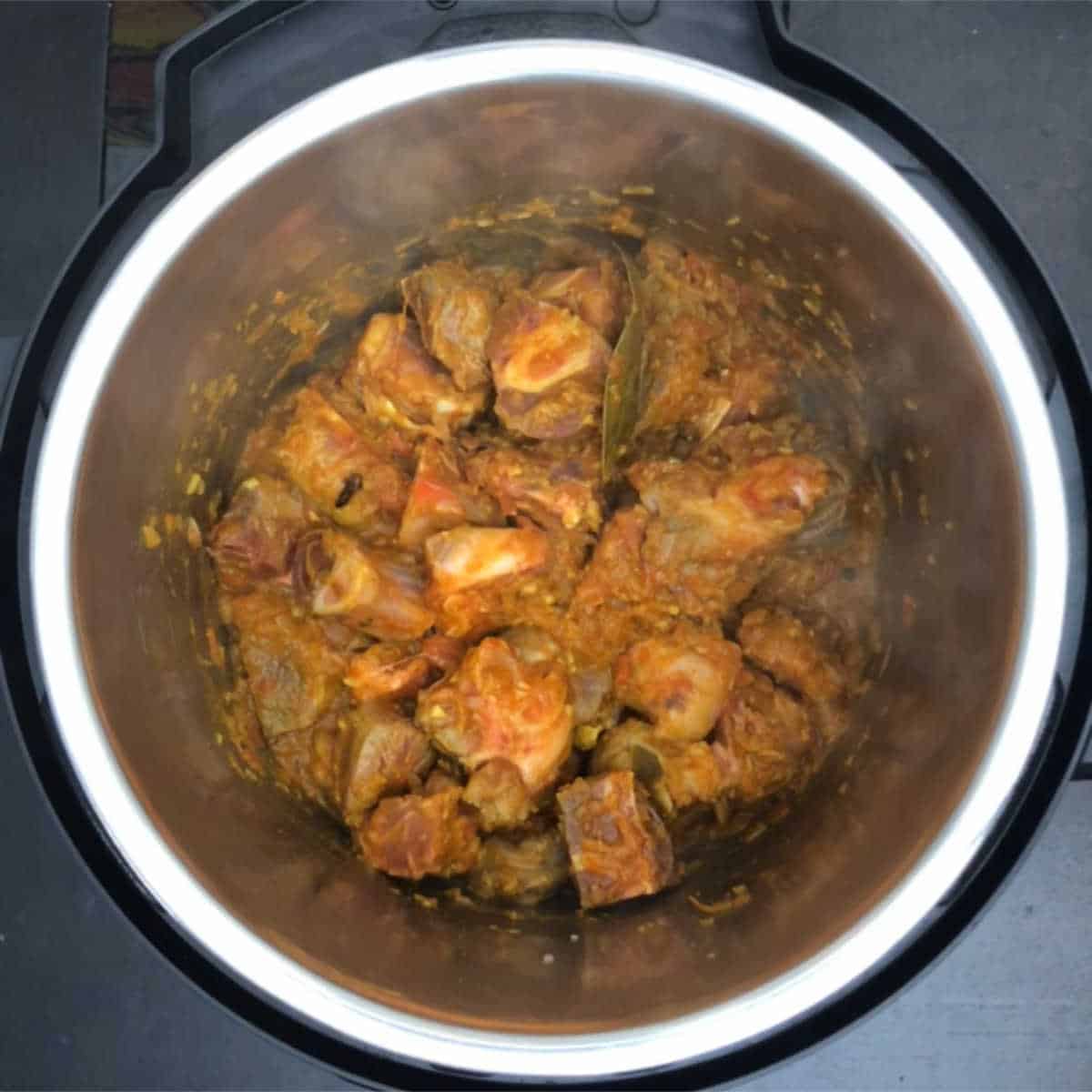Step showing the browned lamb meat in the masala base.