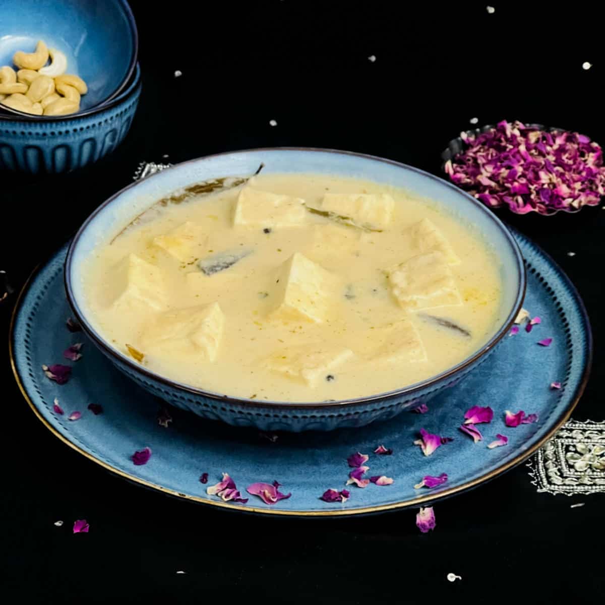 Restaurant style shahi paneer placed in a blue bowl.