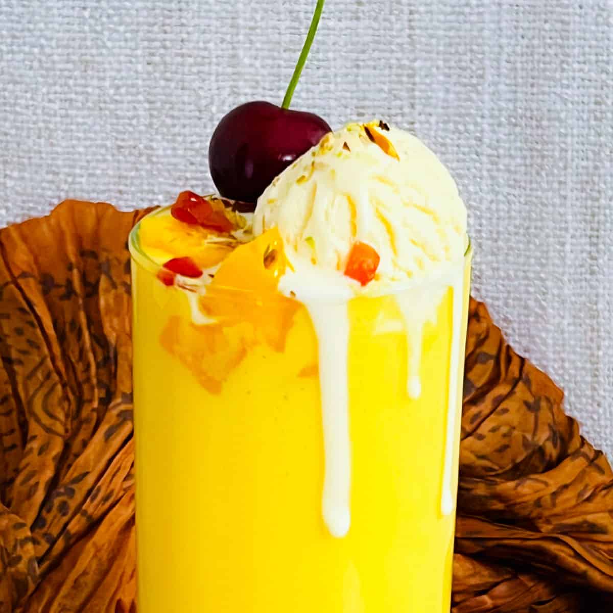 A close up of mango mastani showing the toppings.