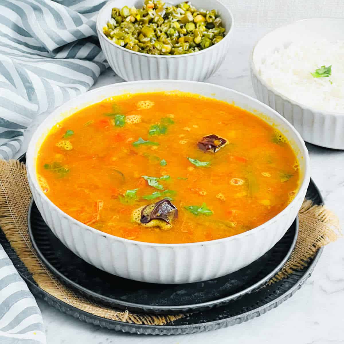 Mysore rasam served with rice and beans poriyal.