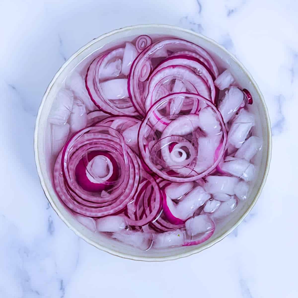 Step showing soaking of the cut onion in ice water.