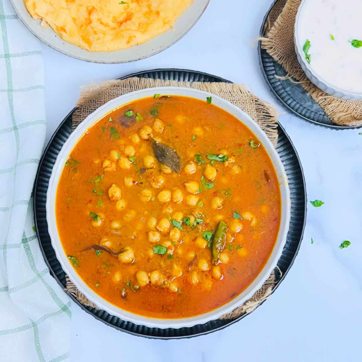 South Indian chana masala served with poori and rice.