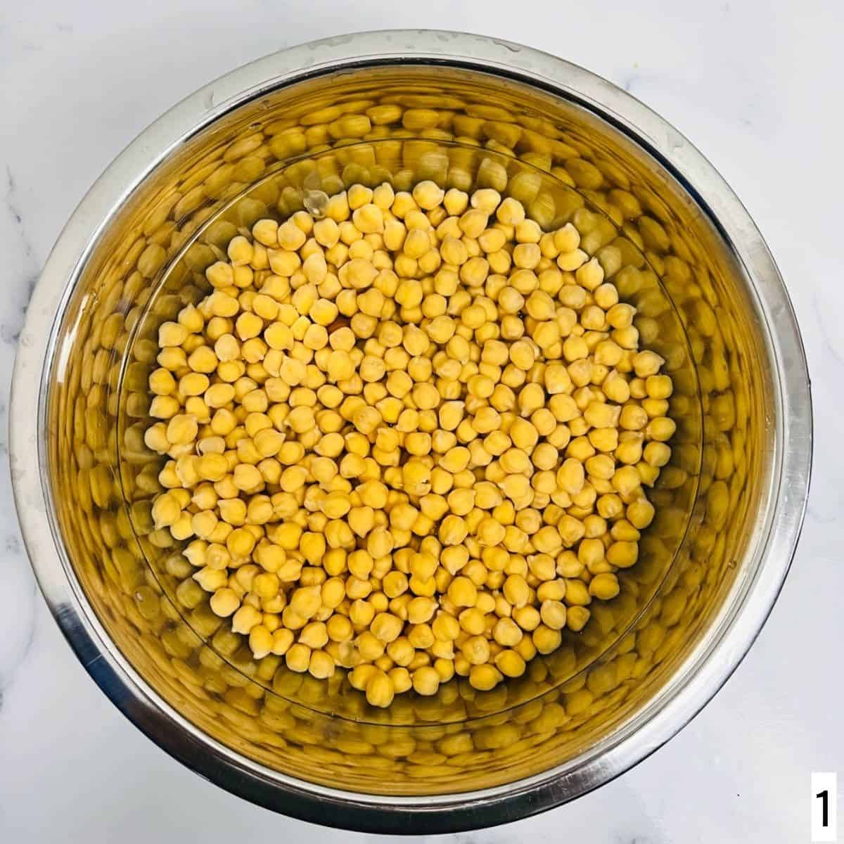 Step showing soaking of chickpeas in water.