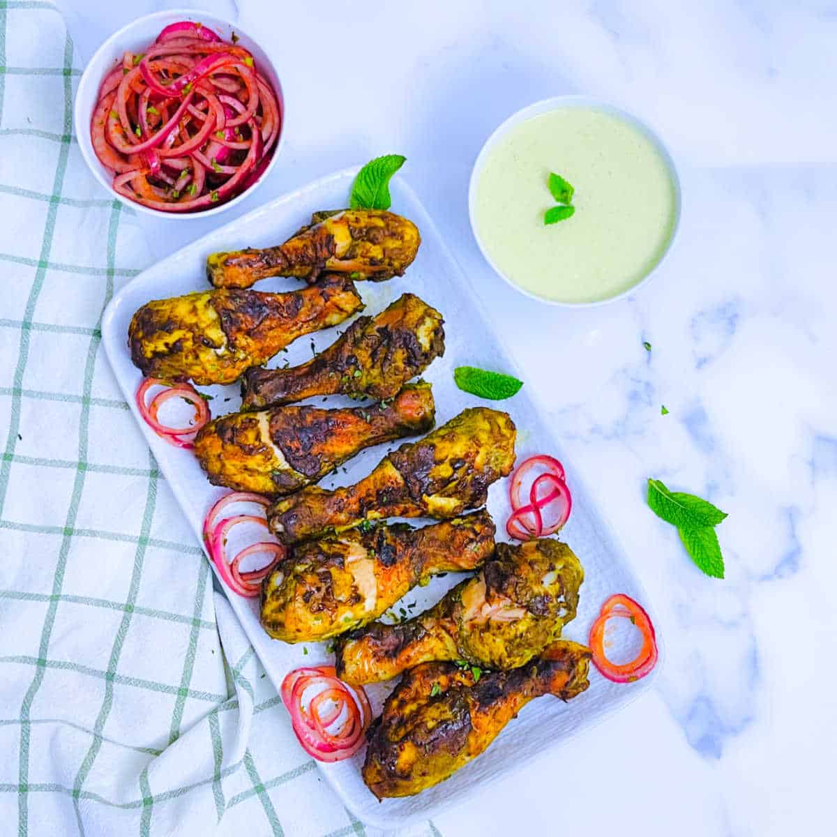 Chicken kebabs served with lachha pyaz.