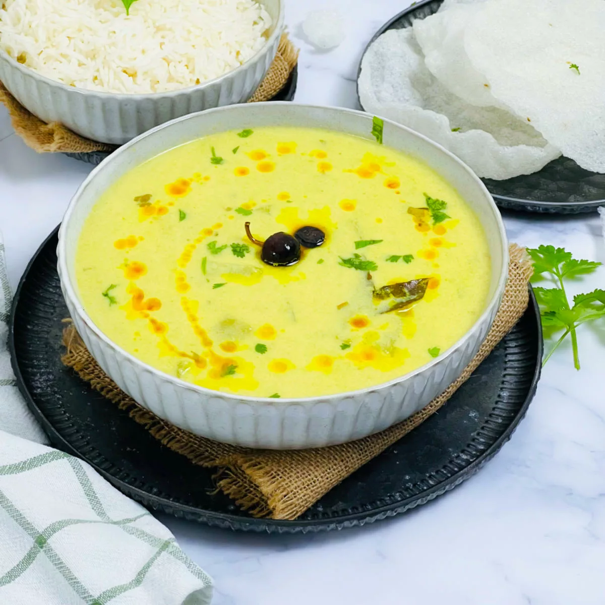 South Indian majjige huli served in a white bowl.