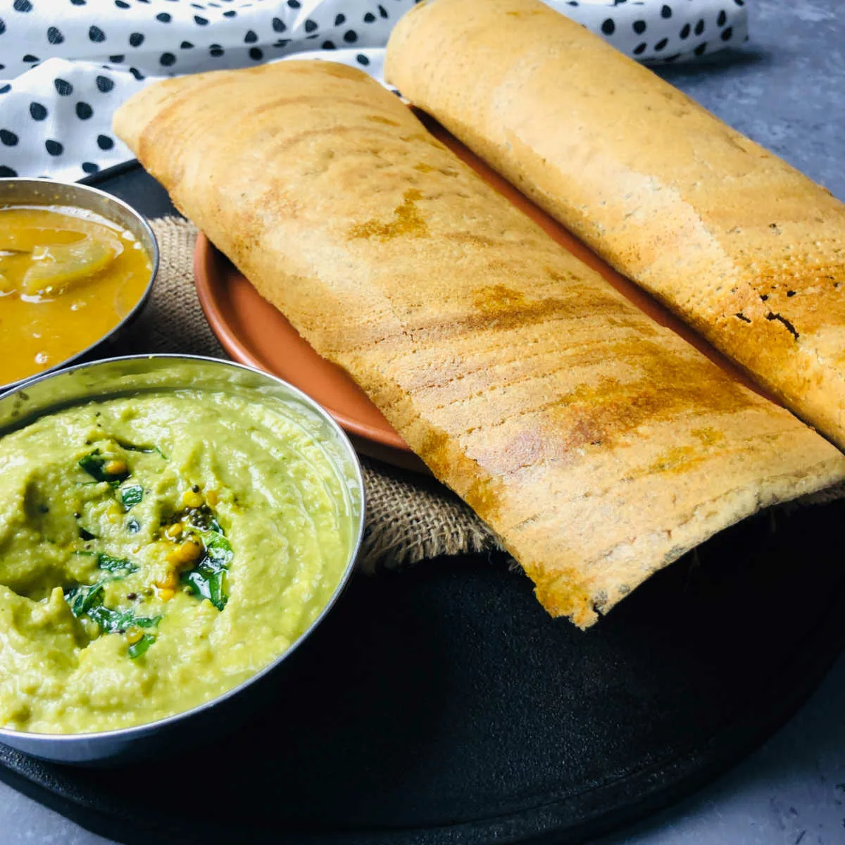 Chutney and sambar served with the millet dosa.