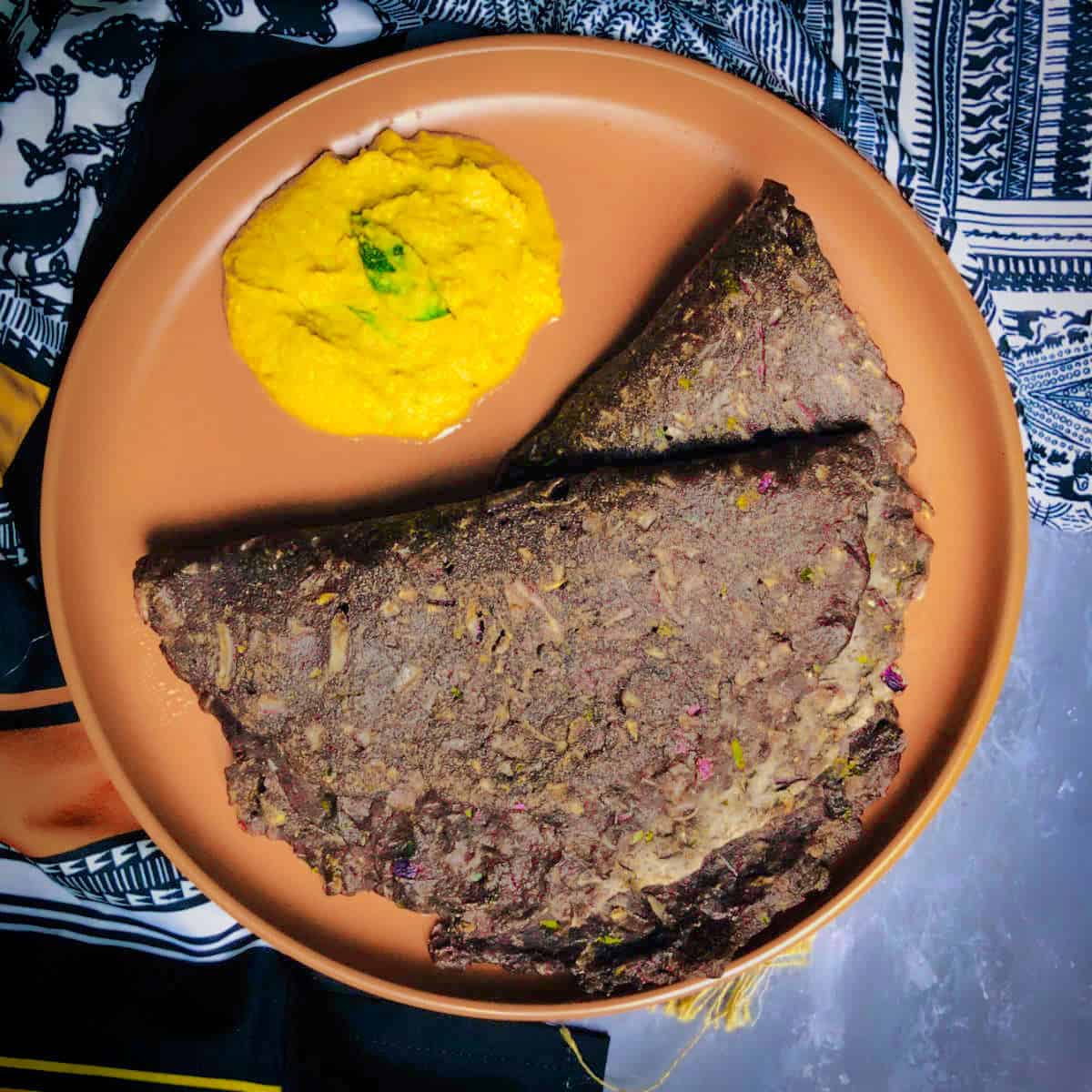 Individual serving of ragi rotti and chutney on a plate.