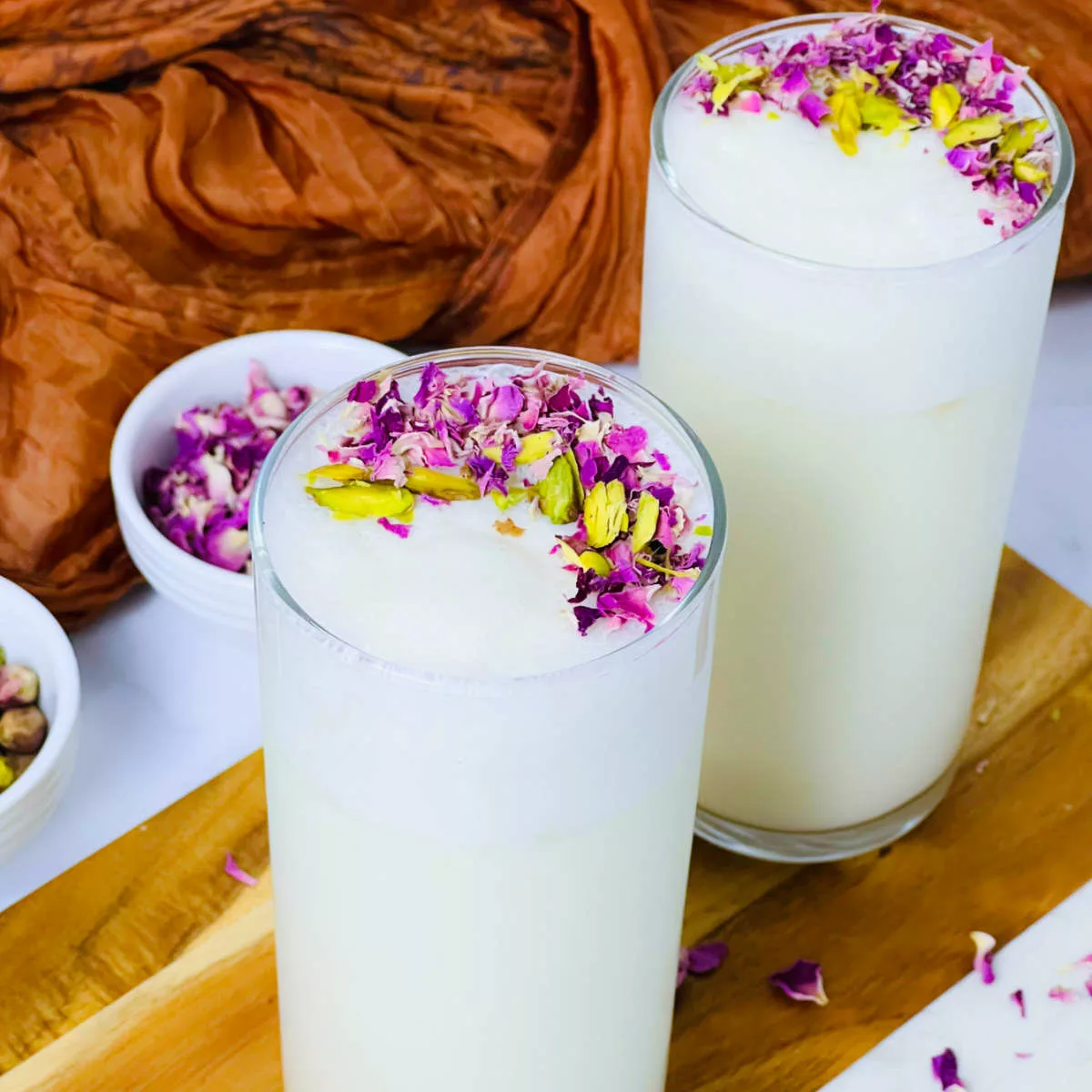 Sweet lassi placed in 2 hiball glasses.