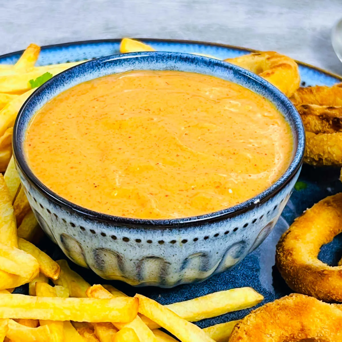 Tandoori mayonnaise served with fries and onion rings.