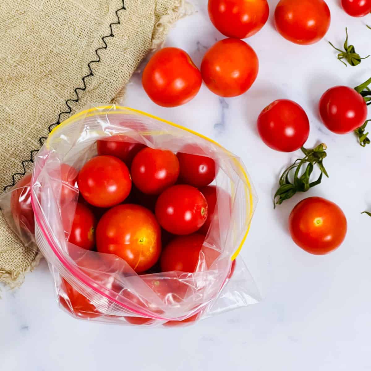 Step showing the filled tomatoes in a freezer-safe bag.