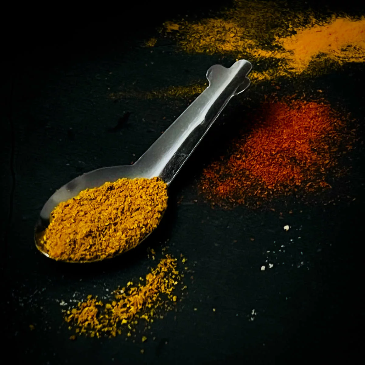 Curry powder in a spoon.