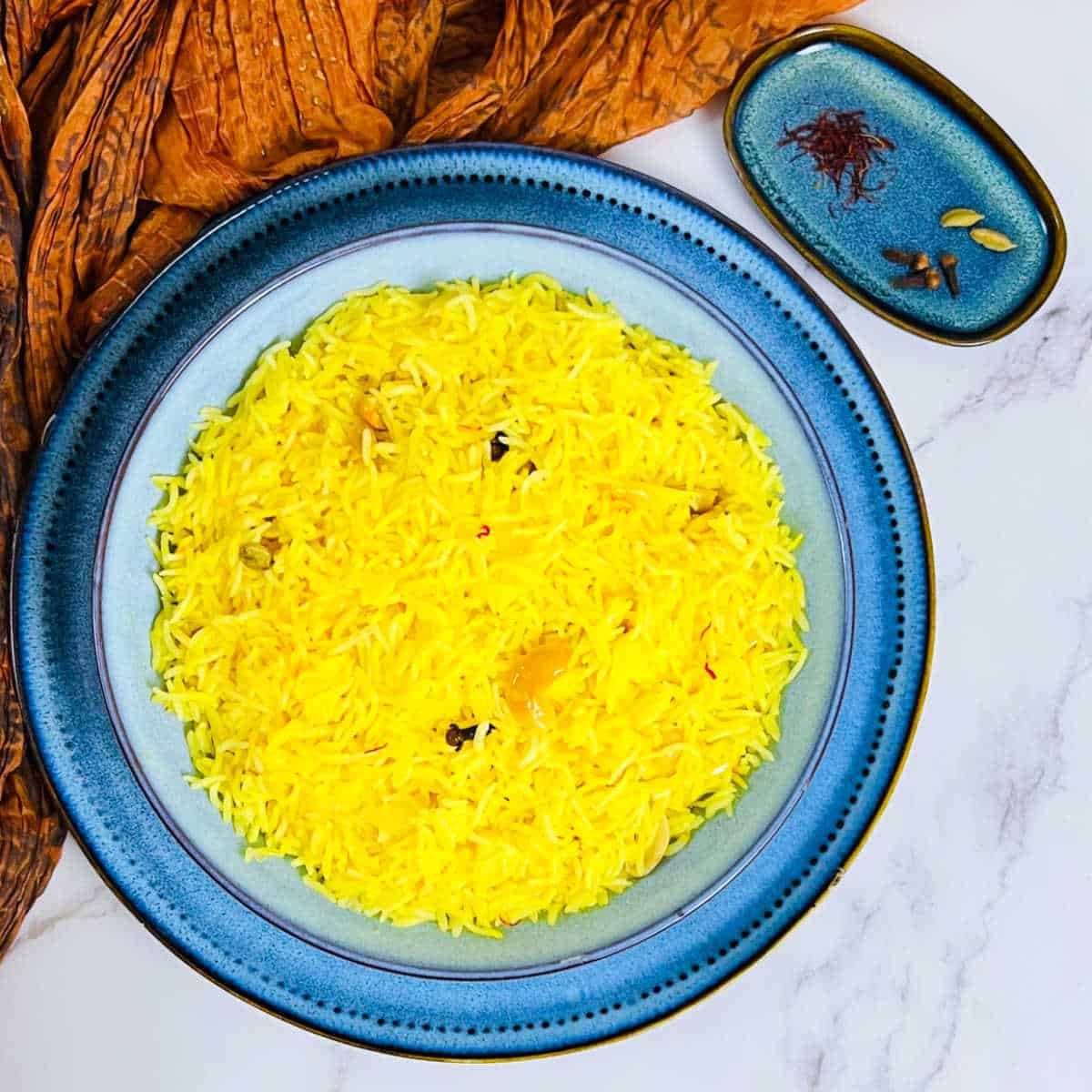Instant Pot saffron rice placed in a blue bowl.