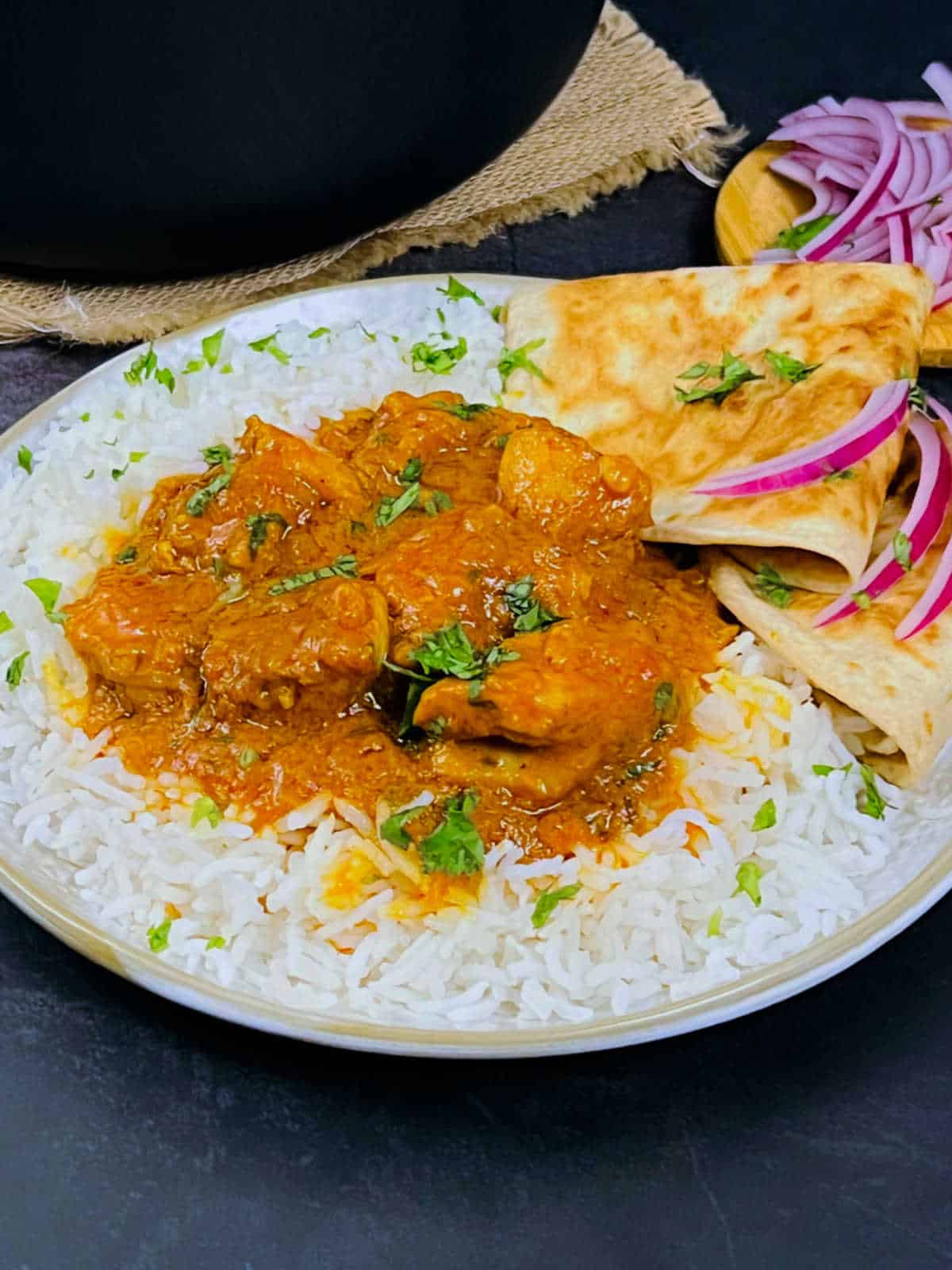 Chicken masala served with rice.