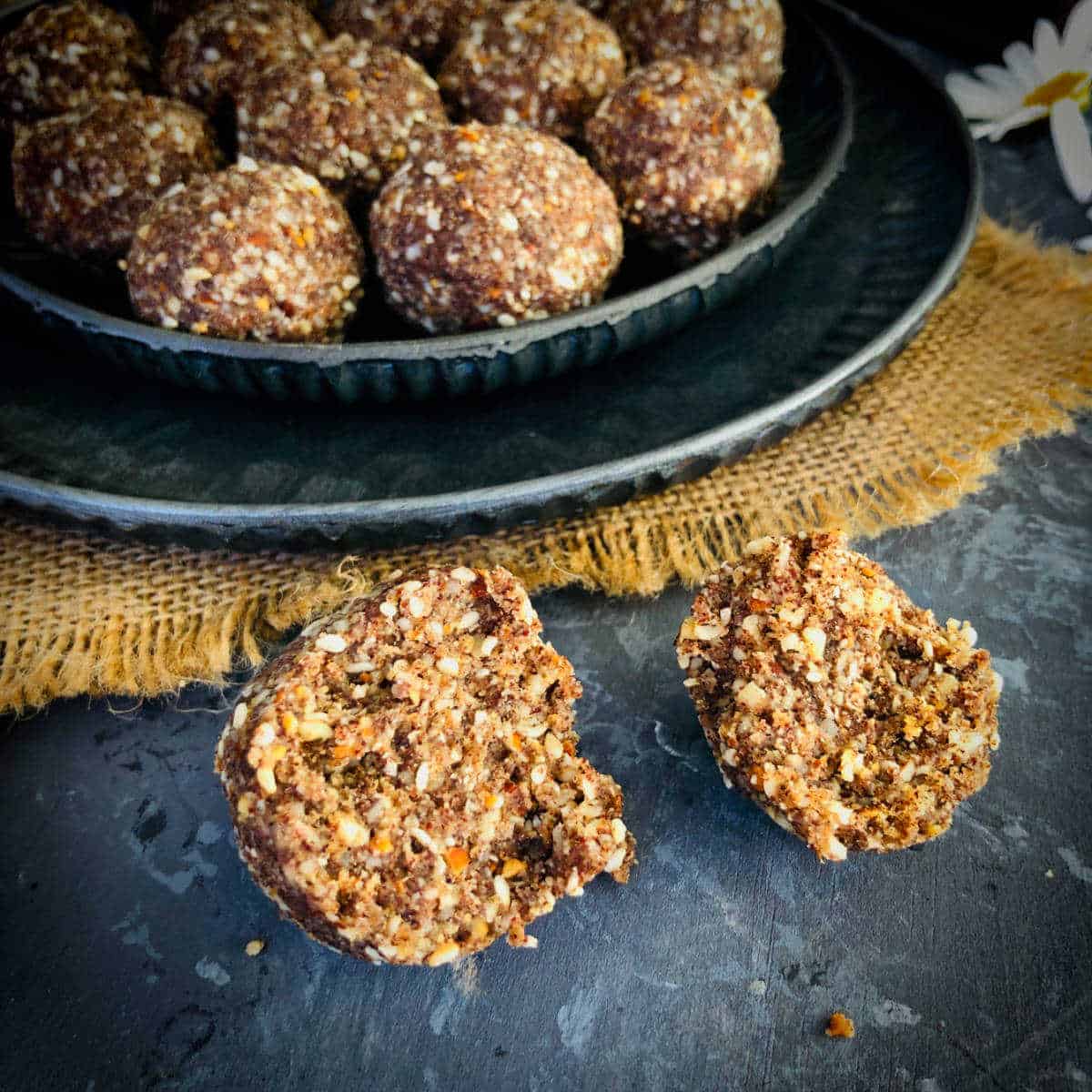 Ragi laddu cut into 2 pieces to show the texture.