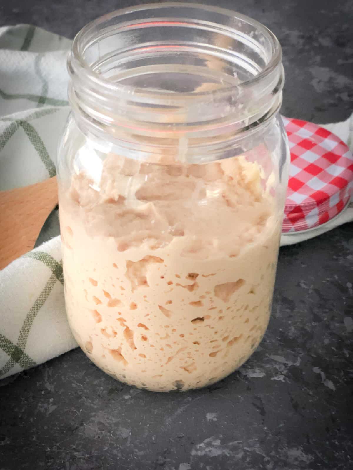Sourdough starter made with atta placed in a jar.