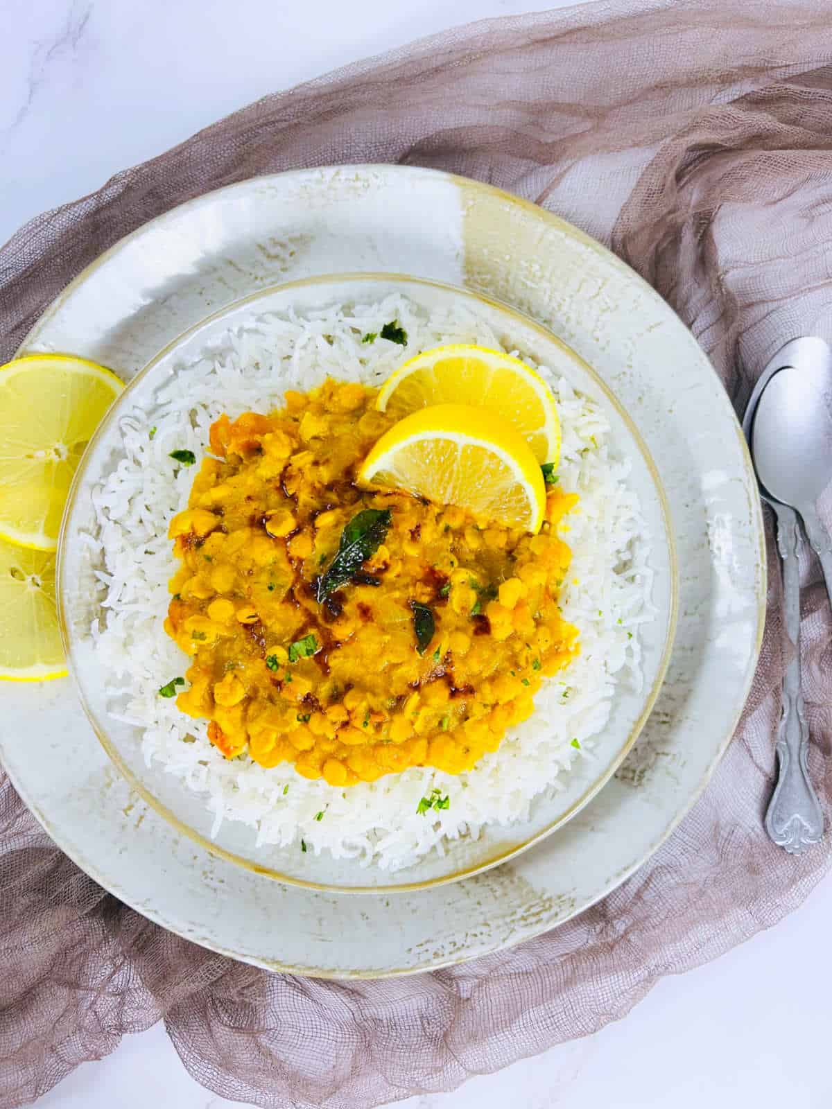 Instant Pot chana dal served on a bed of white rice on a plate.
