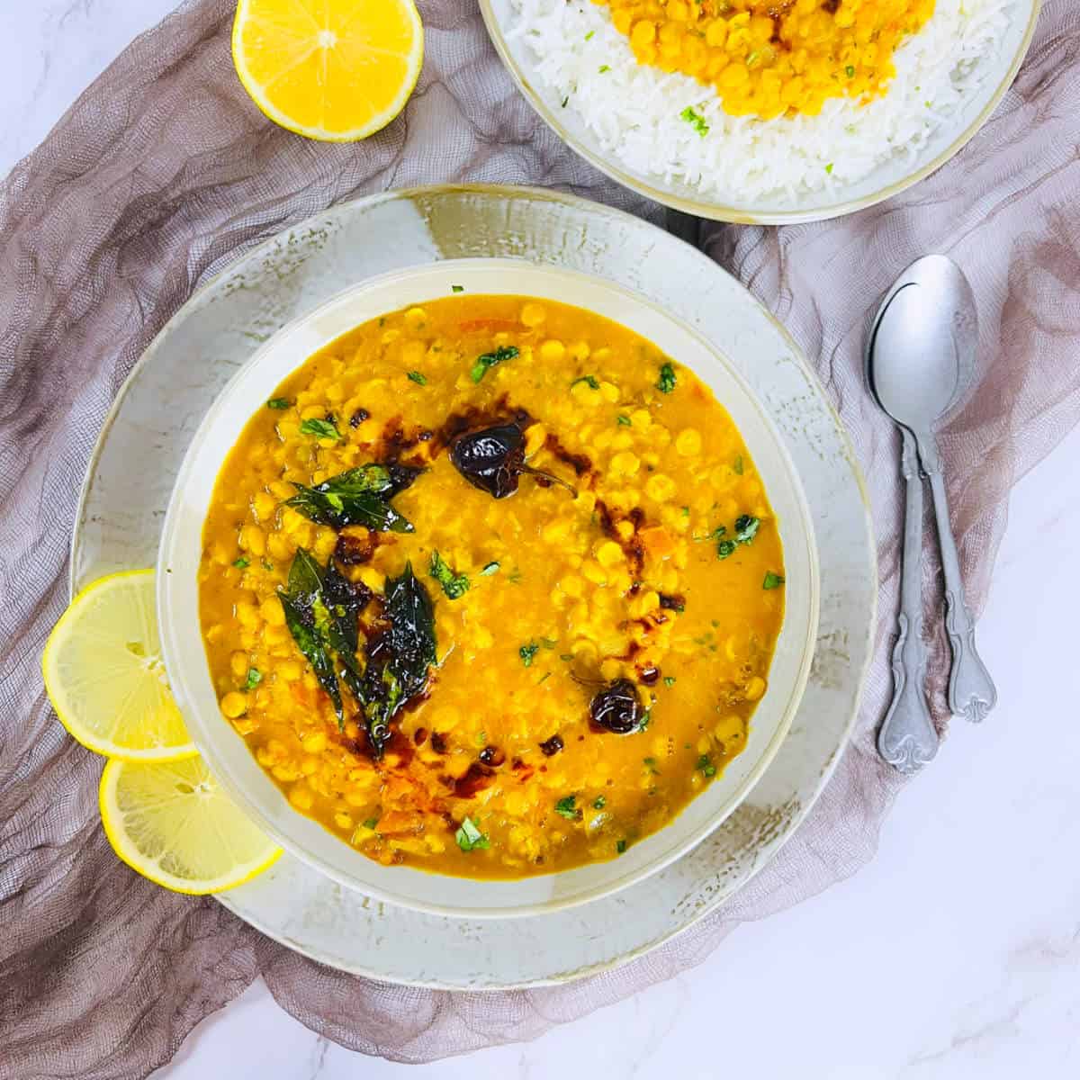 Instant Pot chana dal served in a big bowl on a marble surface.