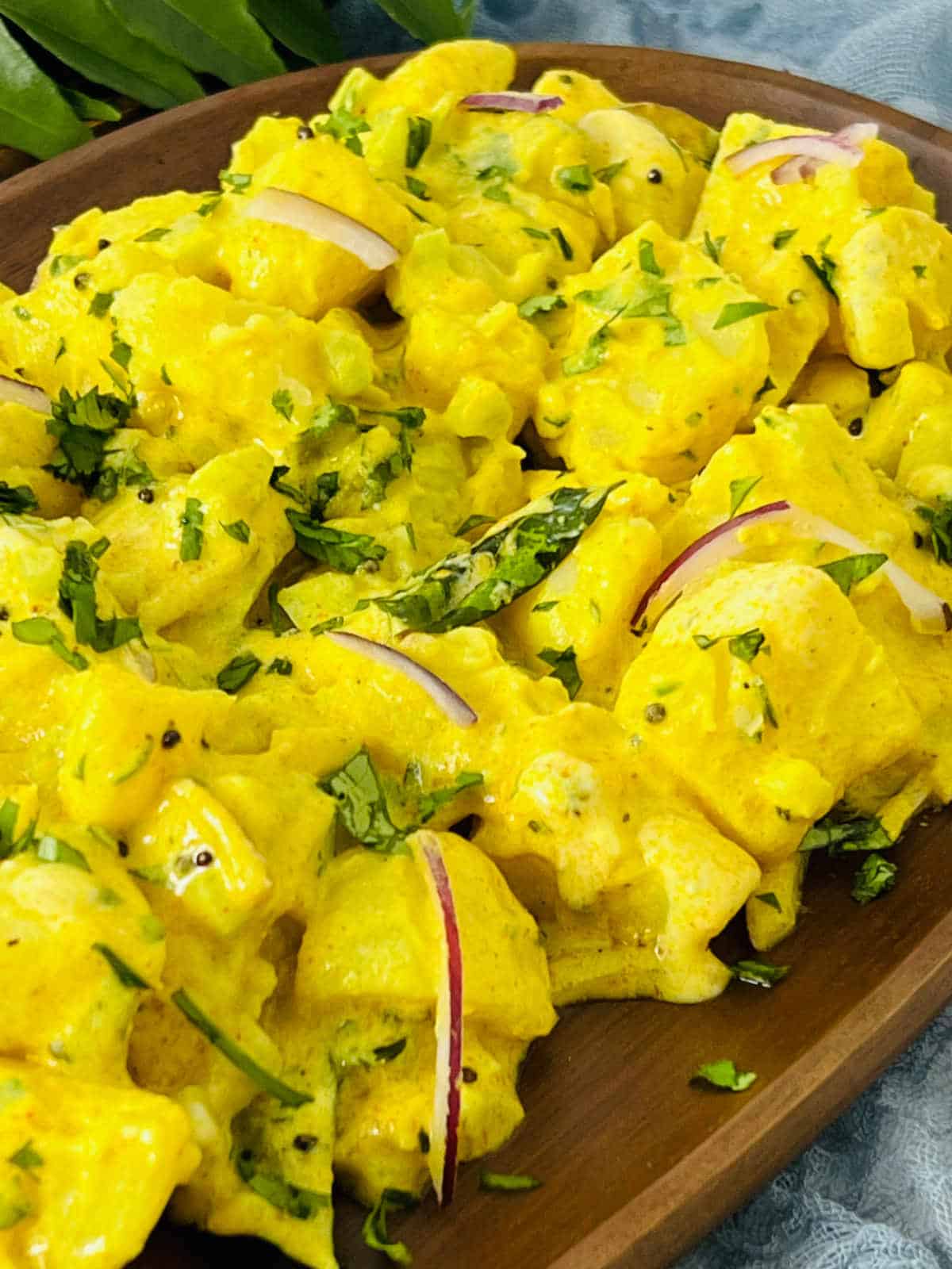 Close-up of curry potato salad to show the textures of potato and dressing.