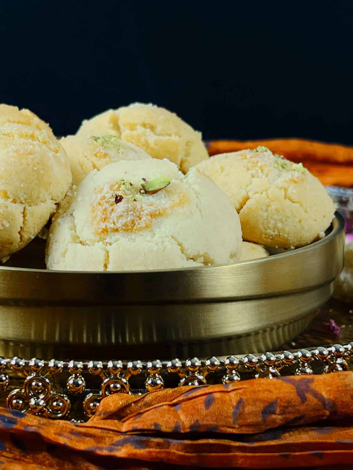 Nankhatai served in a traditional brass bowl.