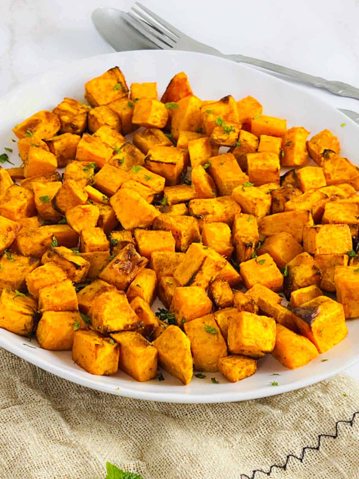 Air fryer sweet potato cubes garnished with cilantro.
