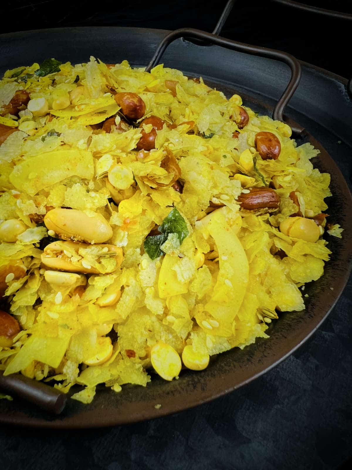 Close up of poha chivda showing the crispy texure and nuts.