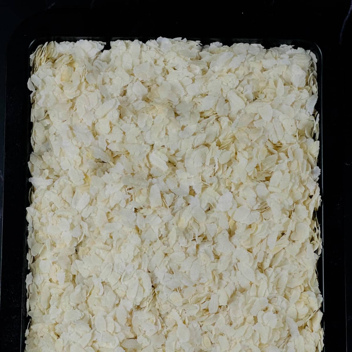 Dry roast the flattened rice in the oven.