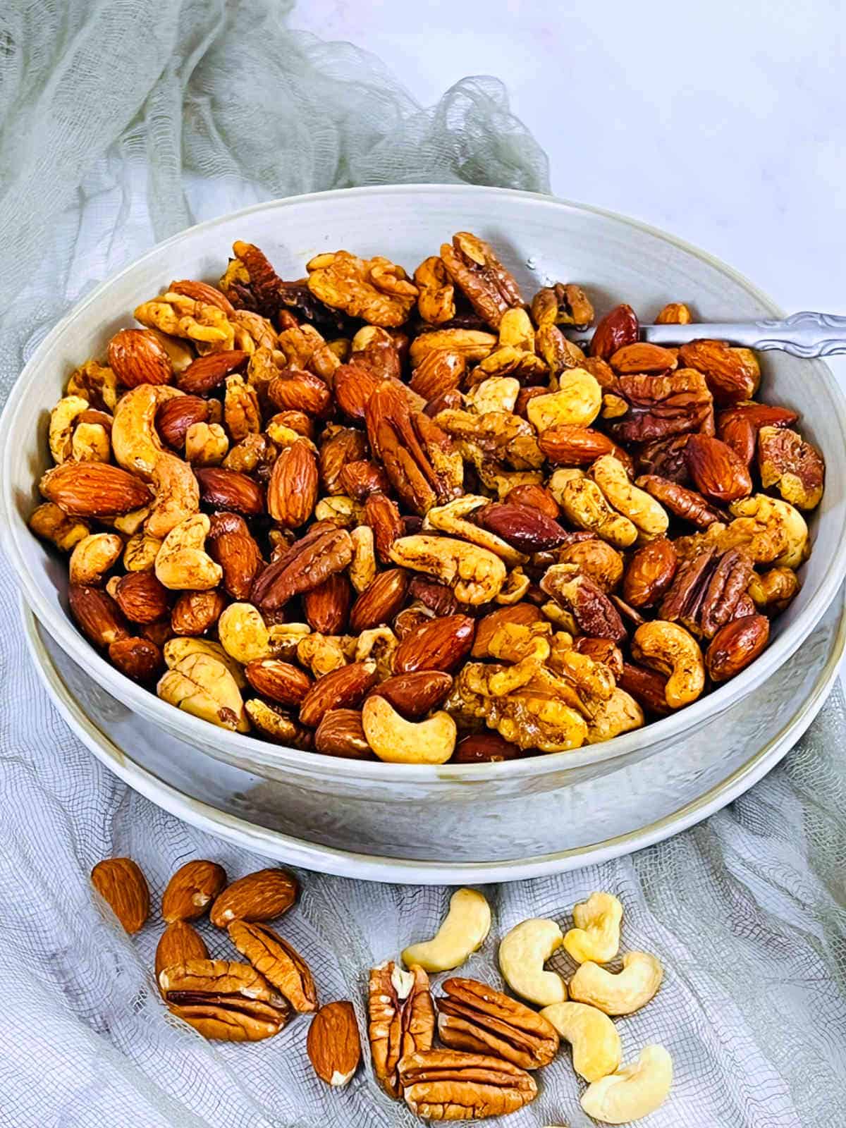 Roasted nuts in a brown bowl.