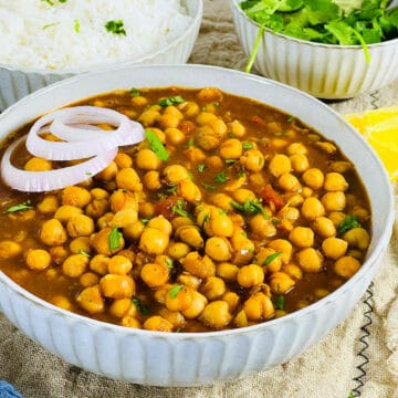 Chana masala curry placed in a white bowl.