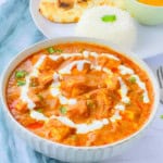 Matar paneer in a white bowl.