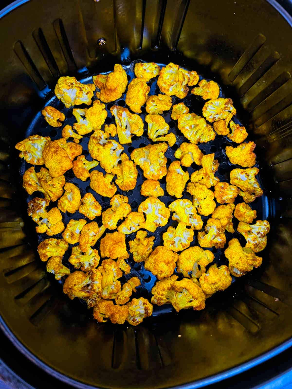 Crispy roasted florets in the air fryer basket.