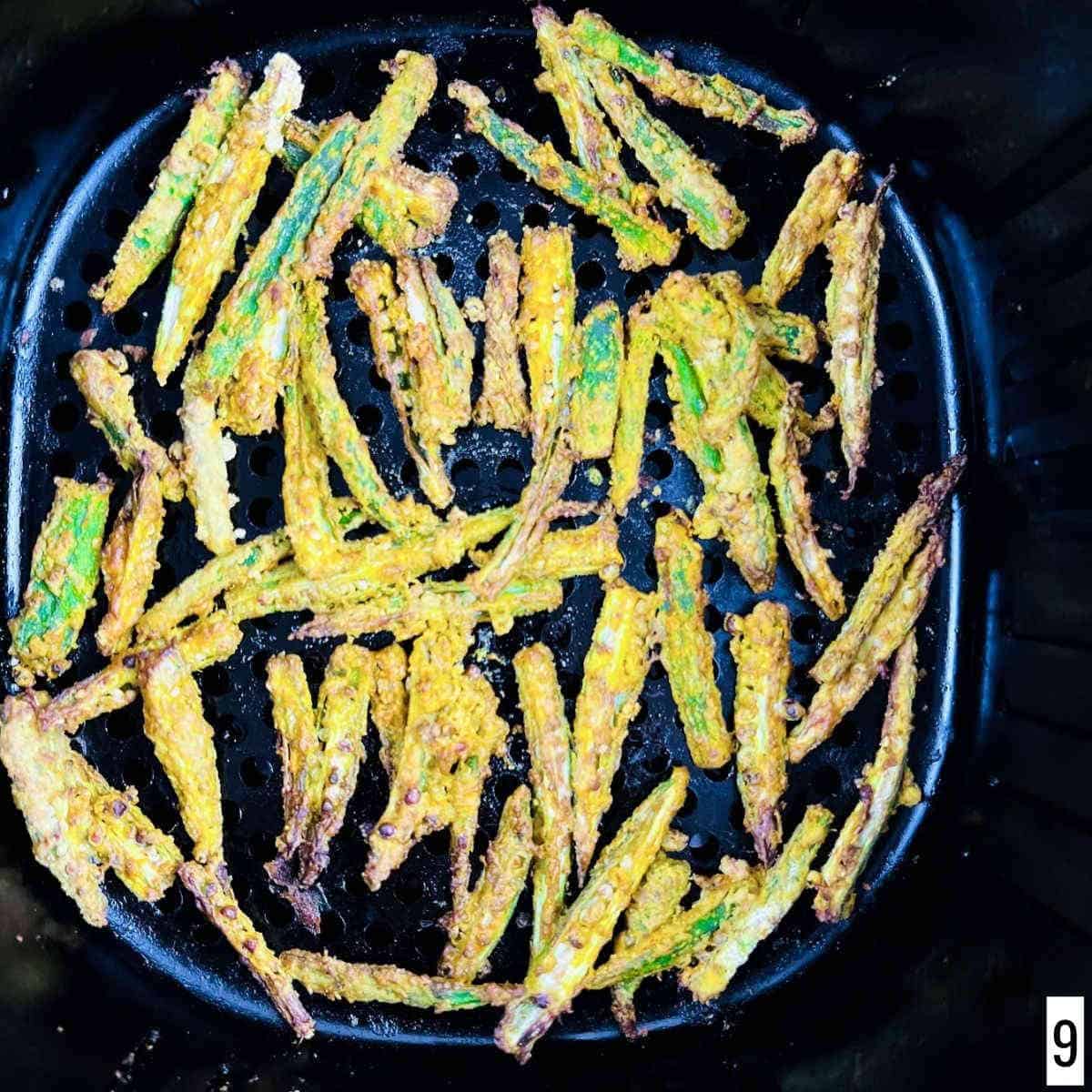 Crispy and crunchy air-fried okra in the air fryer basket.