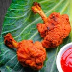 Chicken lollipop served with sauce.