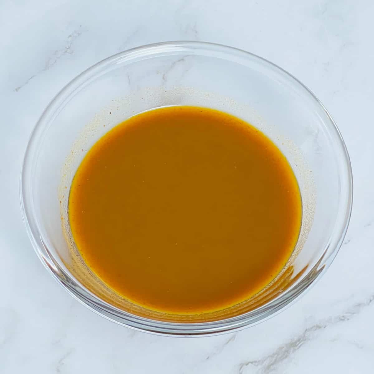 Pumpkin chai concentrate placed in a glass bowl.