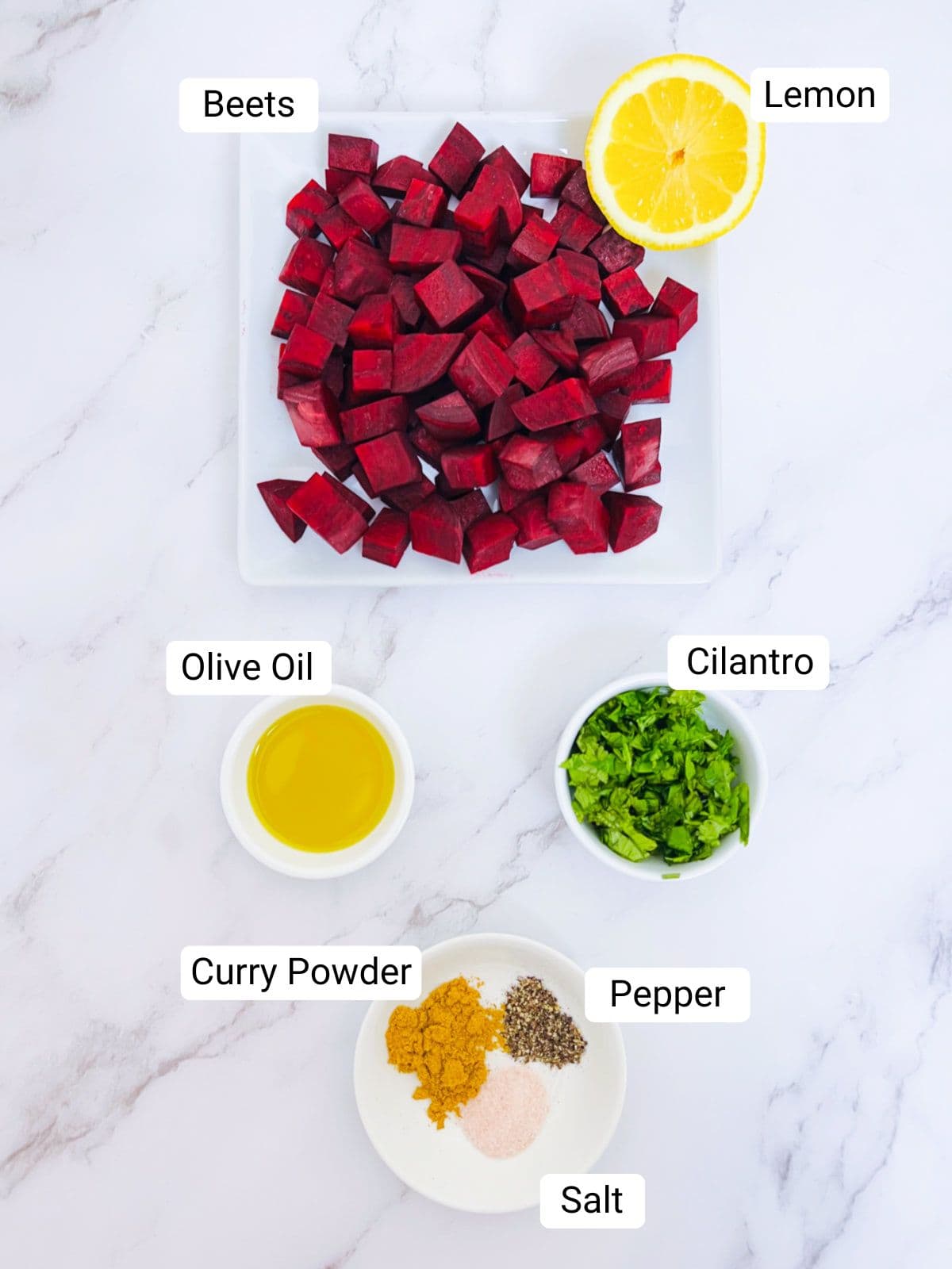 Ingredients to make air fryer beets placed on a marble surface.