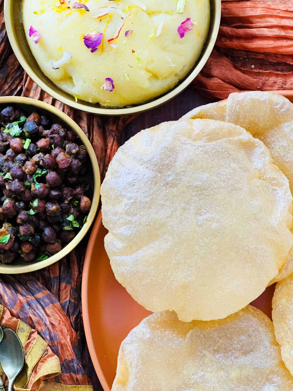 Close up of poori placed on a brown plate.