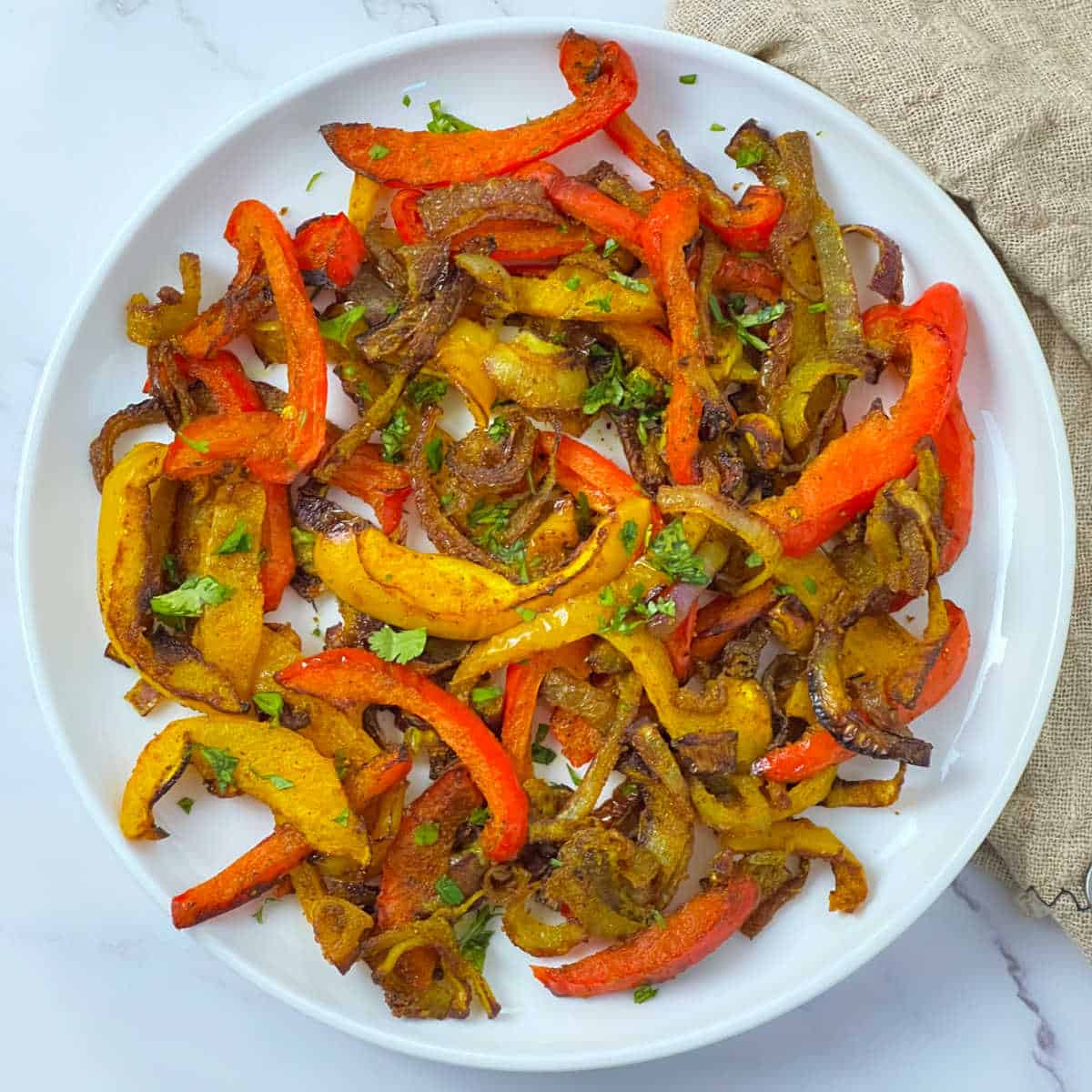 Roasted curry bell peppers on a white plate.