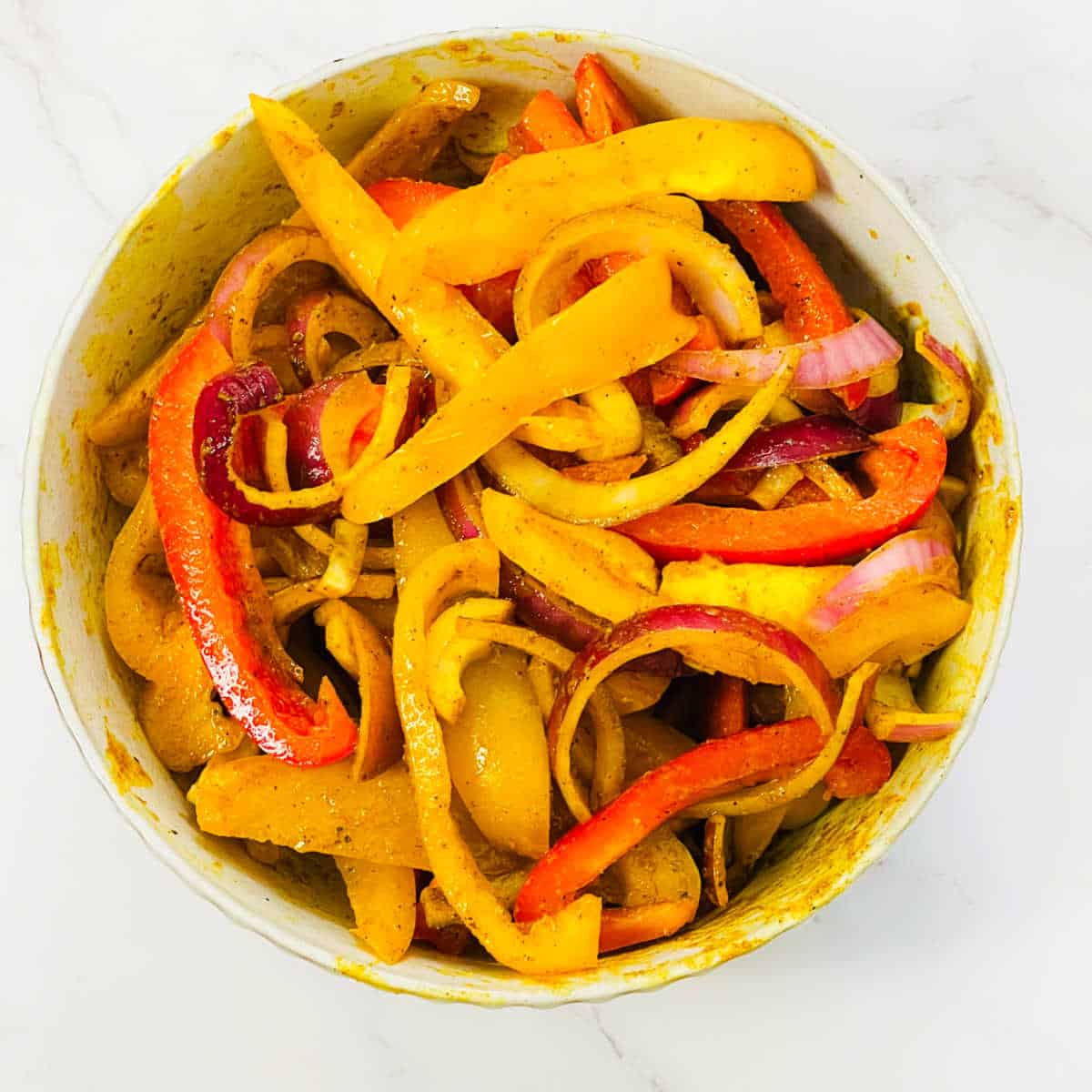 Seasoned bell peppers in a bowl.