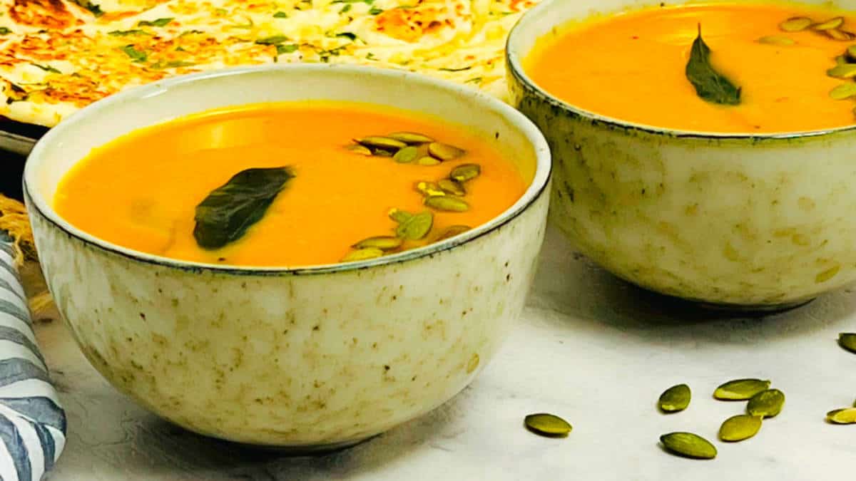 Butternut squash soup served in brown bowls.
