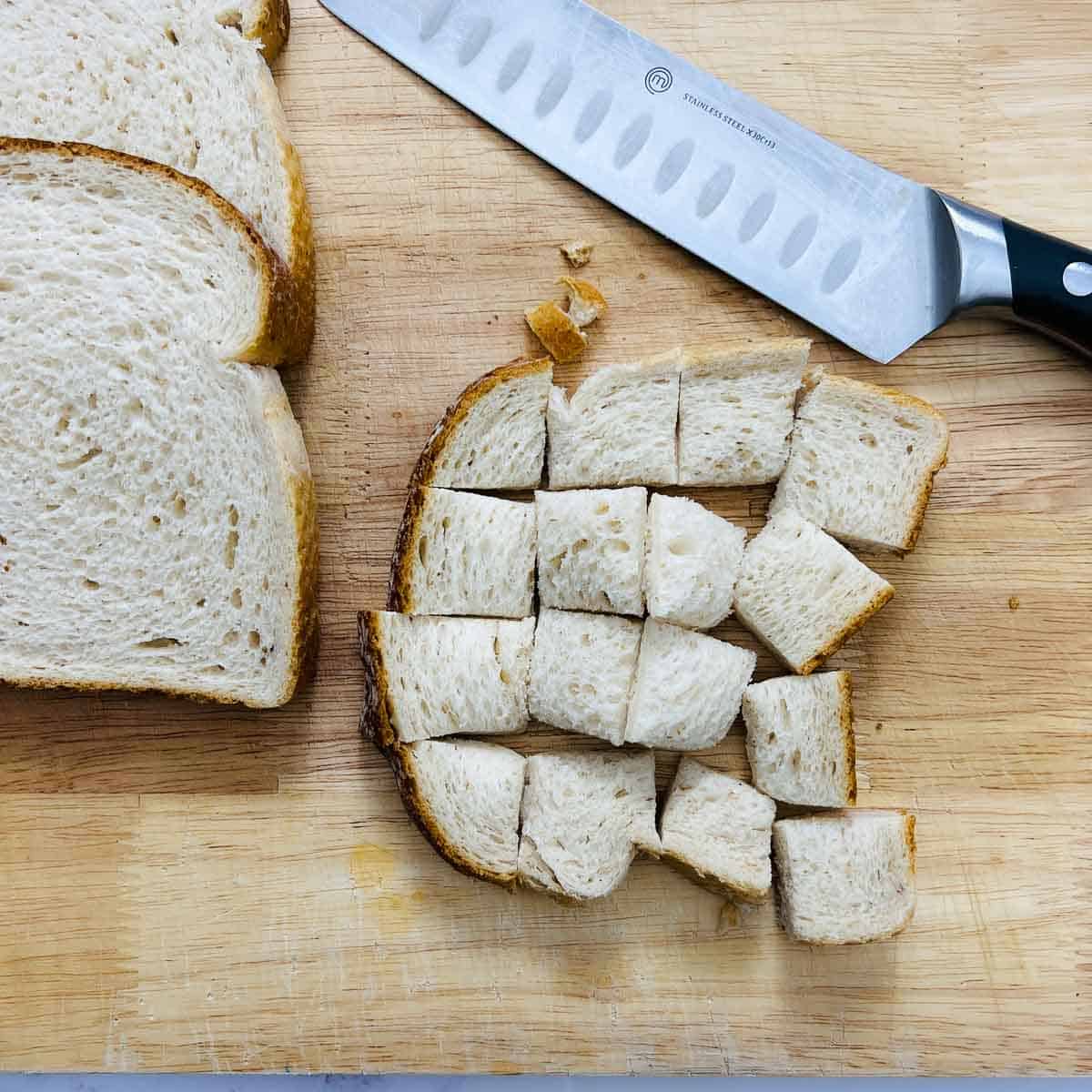 Cut bread slices on a wooden cutting board.
